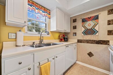 Kitchen with light countertops, white cabinets, wh