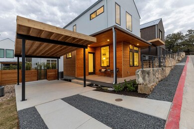 View of side of property featuring metal roof and