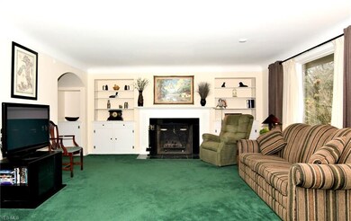 Living Room with fireplace with gas logs and built
