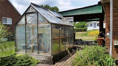 Greenhouse included. Nice covered side porch.