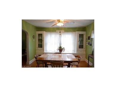 Another view of the formal dining room with a wonderful window seat and leaded glass cabinets.