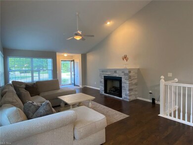 Great room offers a vaulted ceiling and gas log fi