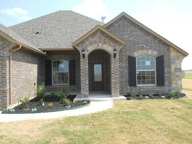 Exterior Front. Grass in beds planted.