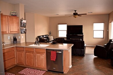 Kitchen with breakfast bar and open to f