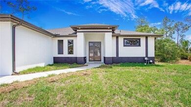 View of front of home featuring stucco siding, a s