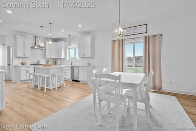 Dining area featuring light wood-style floors, plenty of natural light, a chandelier, and recessed lighting