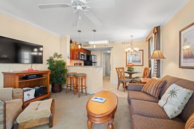 Living room featuring visible vents, crown molding
