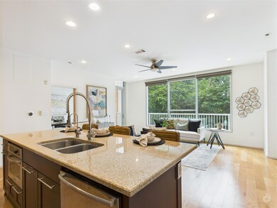 Kitchen featuring dishwasher, light wood-style fl