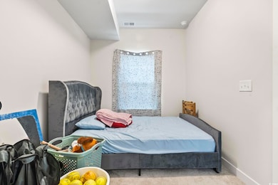 Bedroom with baseboards, carpet flooring, and visi