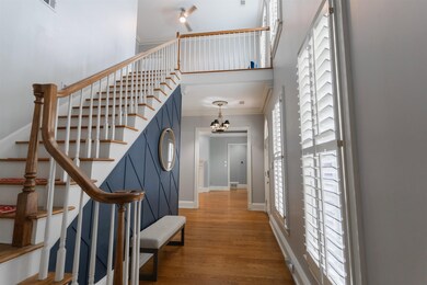 Stairs with ornamental molding, a high ceiling, a 