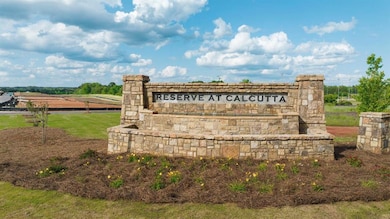 Community / neighborhood sign featuring a rural vi