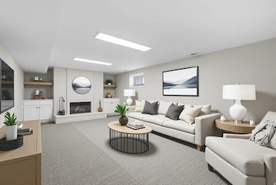 Carpeted living area featuring a brick fireplace and built in shelves