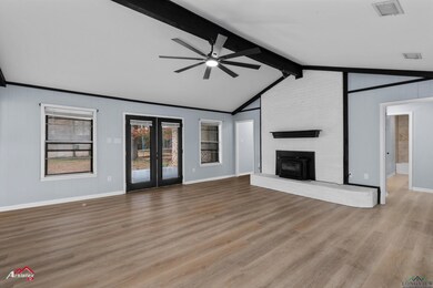 Unfurnished living room featuring vaulted ceiling 