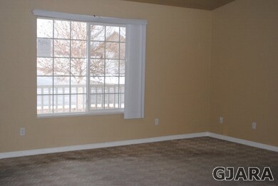 Living room with window coverings.