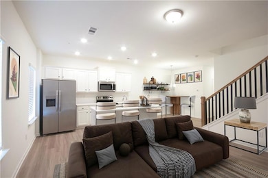 Living room with recessed lighting, stairway, ligh