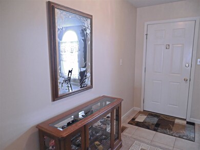 The foyer with ceramic tile flooring opens to the.