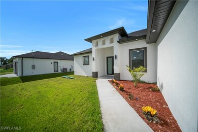 Doorway to property featuring stucco siding, a yar