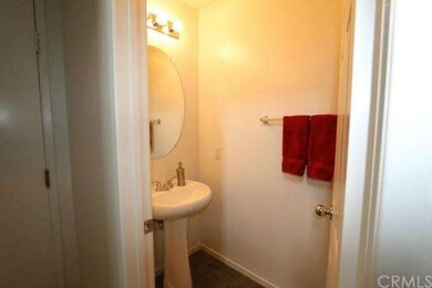 Downstairs half bath. Toilet and a sink. Door to t