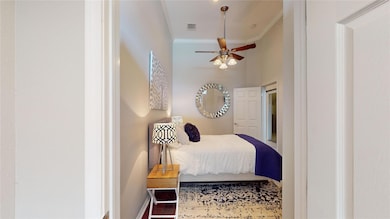 Bedroom with crown molding and baseboards