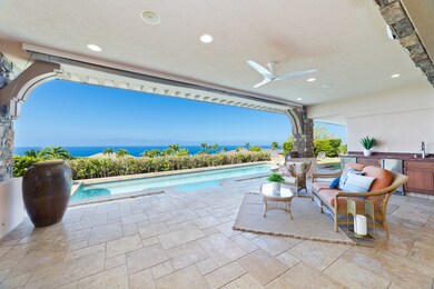 Covered lanai with ocean views, wet bar, and access to the heated pool and spa.