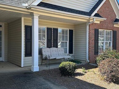 View of front facade with concrete driveway, brick siding, a garage, and a shingled roof