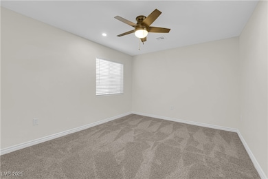 Spare room featuring carpet flooring, a ceiling fa