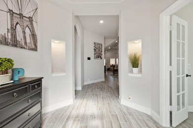 Inviting entry features tall ceilings with lighted