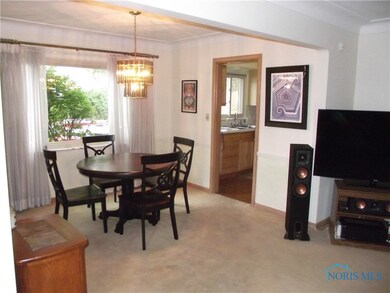 Dining room with coved ceilings and view of kitche