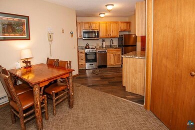 Dining area with dark hardwood / wood-style floori