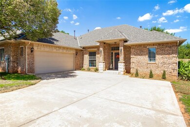 Front of home showing large driveway, two car gara