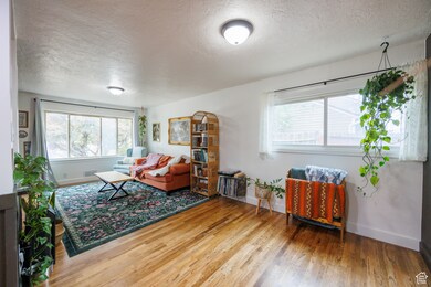 Living area featuring a textured ceiling and light wood finished floors