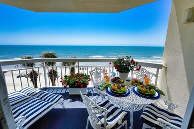 Balcony with view of water and beach
