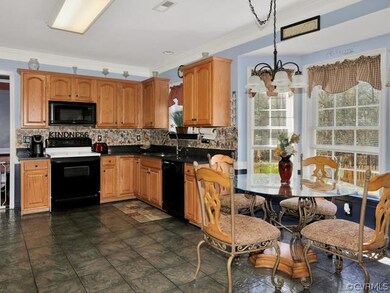 View of kitchen showing tile floor and eat in area