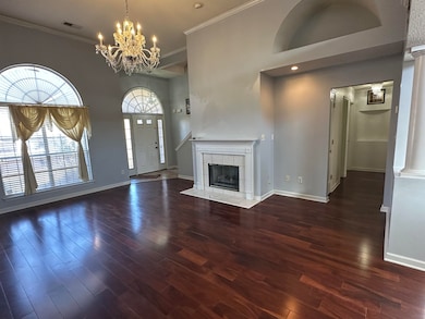 Unfurnished living room featuring dark hardwood / 