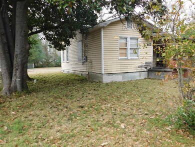 View of side of property with a yard