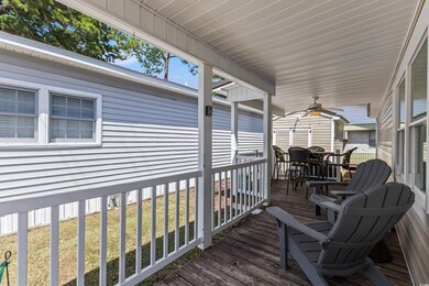Deck featuring ceiling fan and a lawn