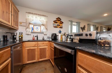 The kitchen is equipped with ample cabinetry and a delightful window above the sink for added natura