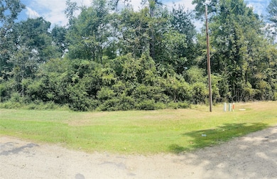View of lot frontage with visible power lines and utility markers along property edge
