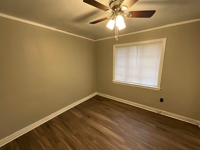 Unfurnished room featuring dark wood-style floors,