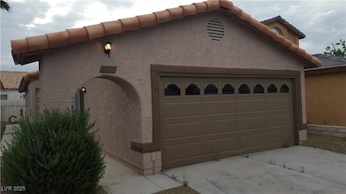 View of front of house featuring a tile roof, stuc