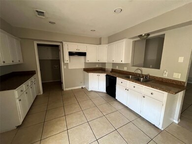 Kitchen featuring light tile patterned floors, a s