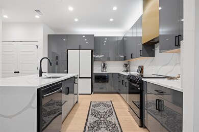 Kitchen featuring a sink, black appliances, gray 