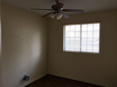 Unfurnished room featuring dark colored carpet, b