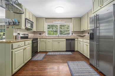 Spacious kitchen with professionally painted cabinets & granite tops.