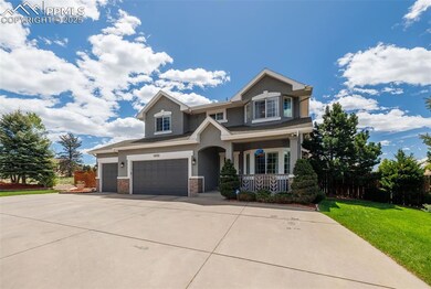 Craftsman-style house with a porch, driveway, an attached garage, stucco siding, and a front lawn