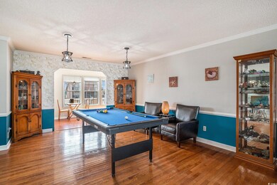 Playroom with crown molding, billiards table, wood finished floors, a textured ceiling, and wallpapered walls