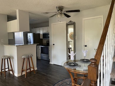 Another view of dining/kitchen area featuring half