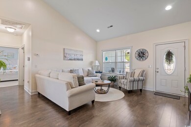 Living room featuring high vaulted ceiling and dar
