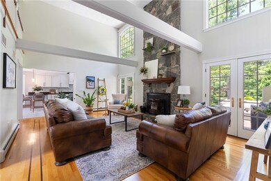 Anchored by two sets of French doors to raised pat
