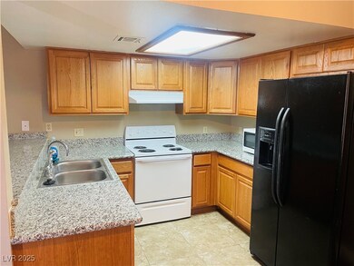 Kitchen with under cabinet range hood